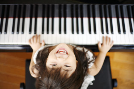 Girl smiling at a piano lesson